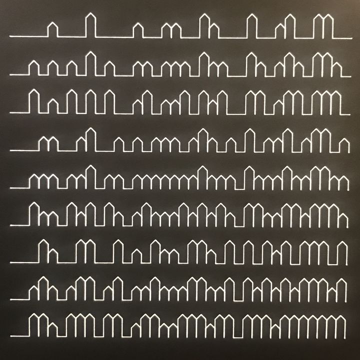 4 trits blocks of houses, white on black, in sequence and connected